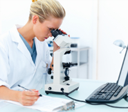 researcher using a microscope