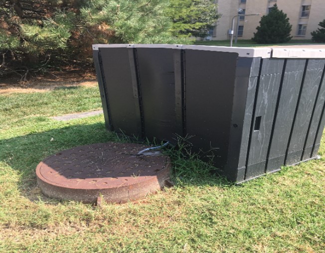 Picture of a manhole with a hut attached ready for wastewater sampling