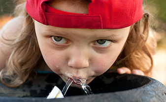 child-drinking-water-fountain