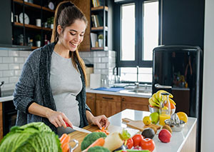 pregnant mom cutting veggies