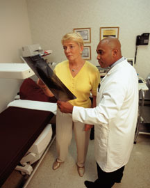 patient and doctor examining an x-ray