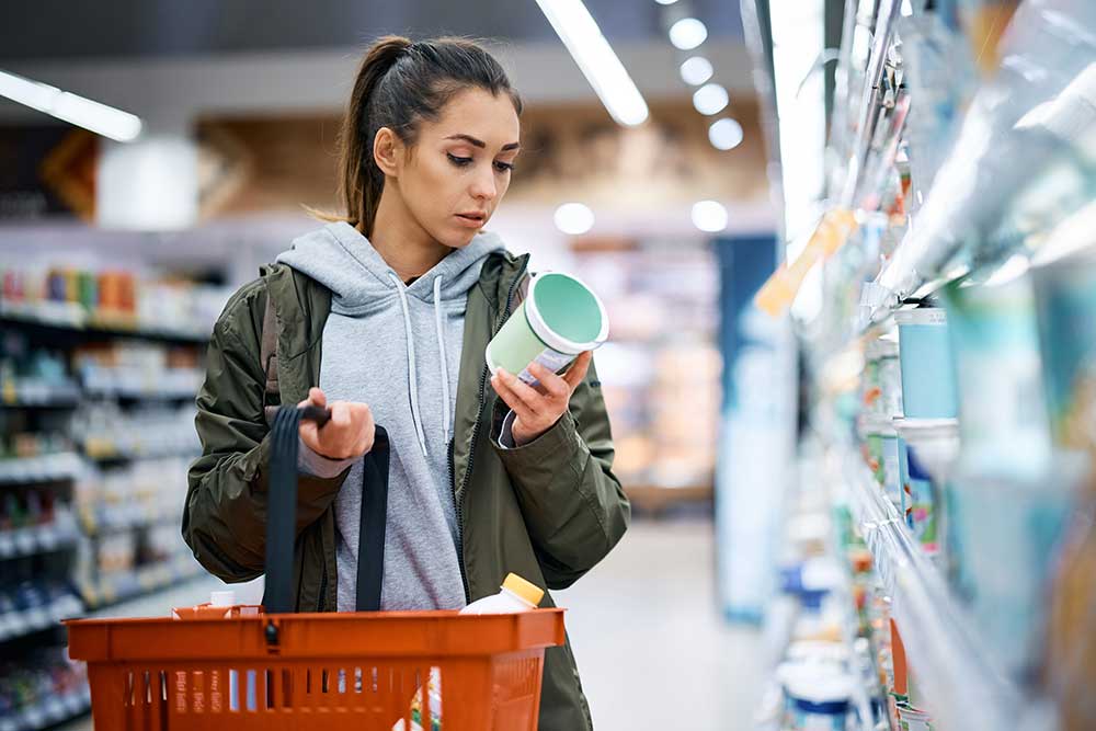 woman reading nutrition label