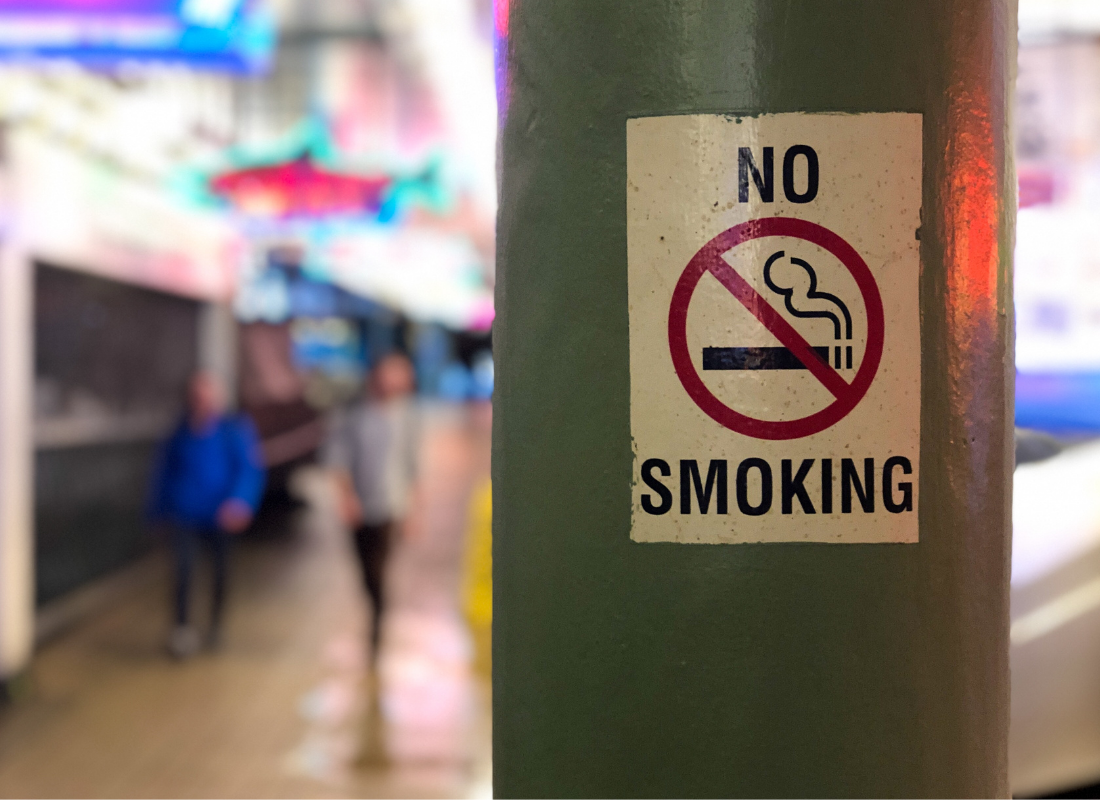 No smoking sign plastered on a pole.