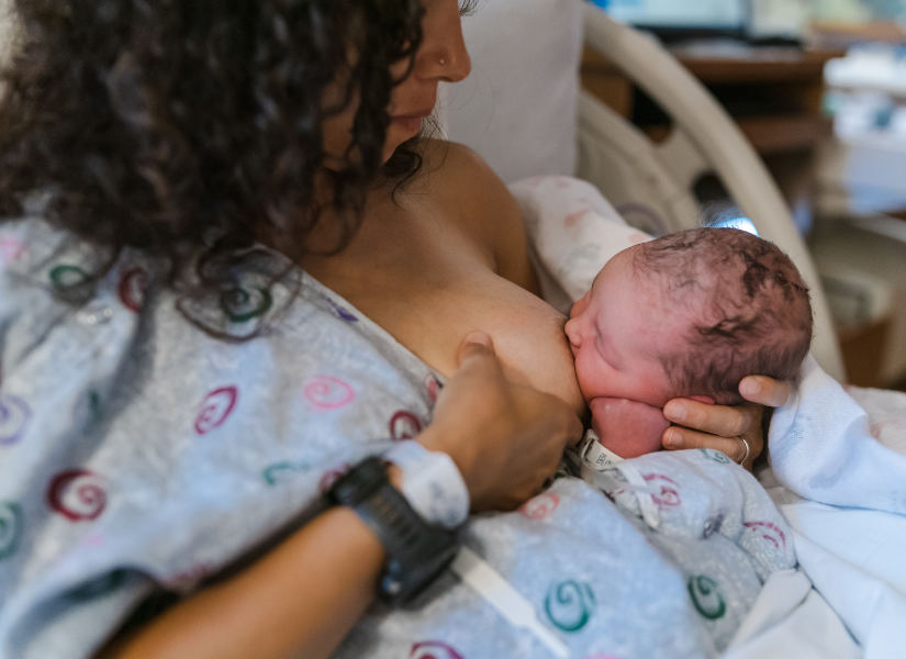 New mom breastfeeding her baby in the hospital after giving birth.