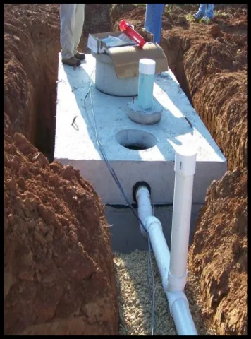 Workers installing a septic tank.
