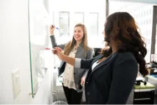 Students writing on whiteboard