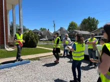 people standing with yellow safety vests