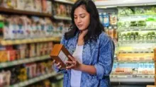woman reading nutrition label